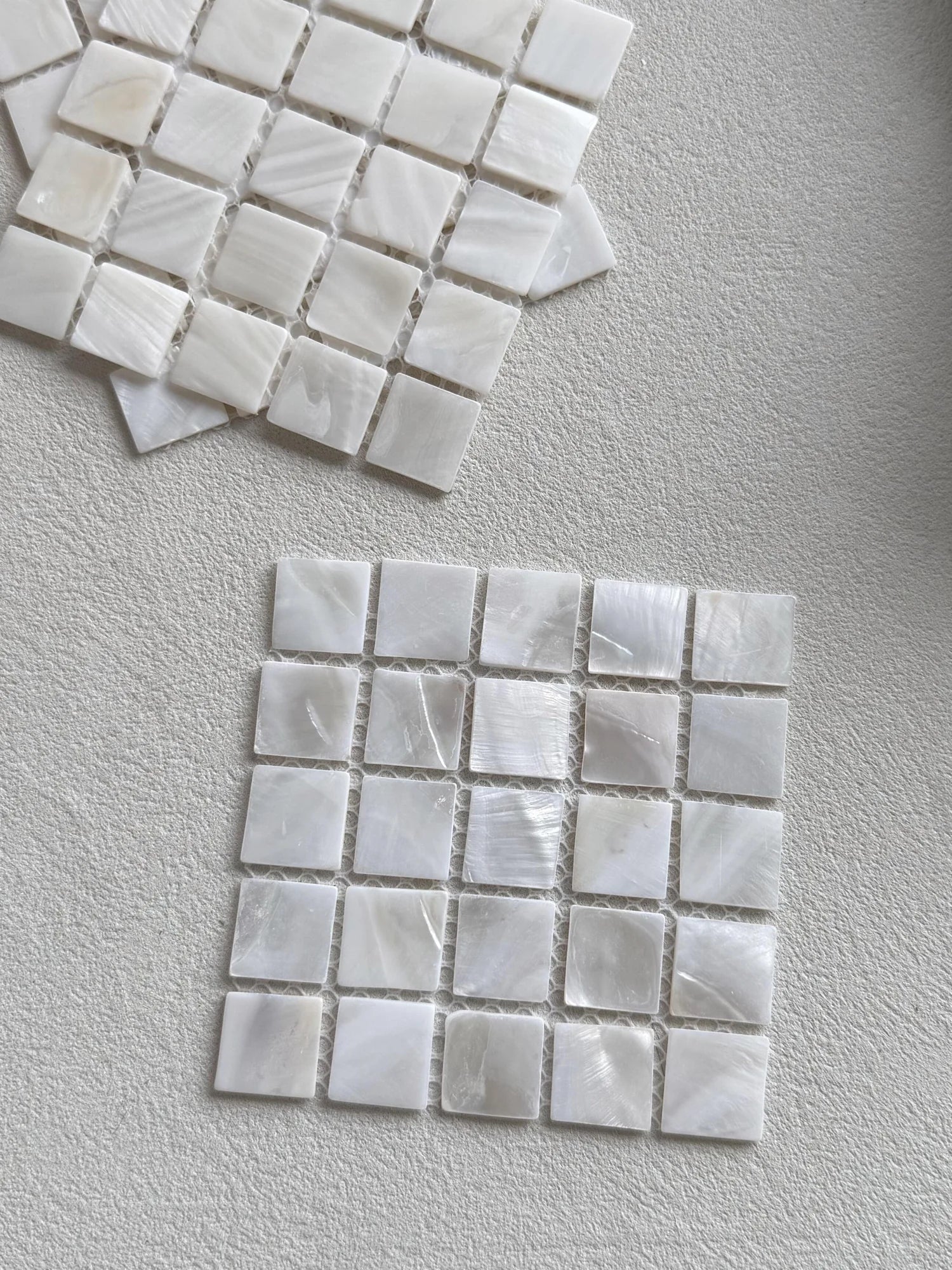 Textured white square tiles