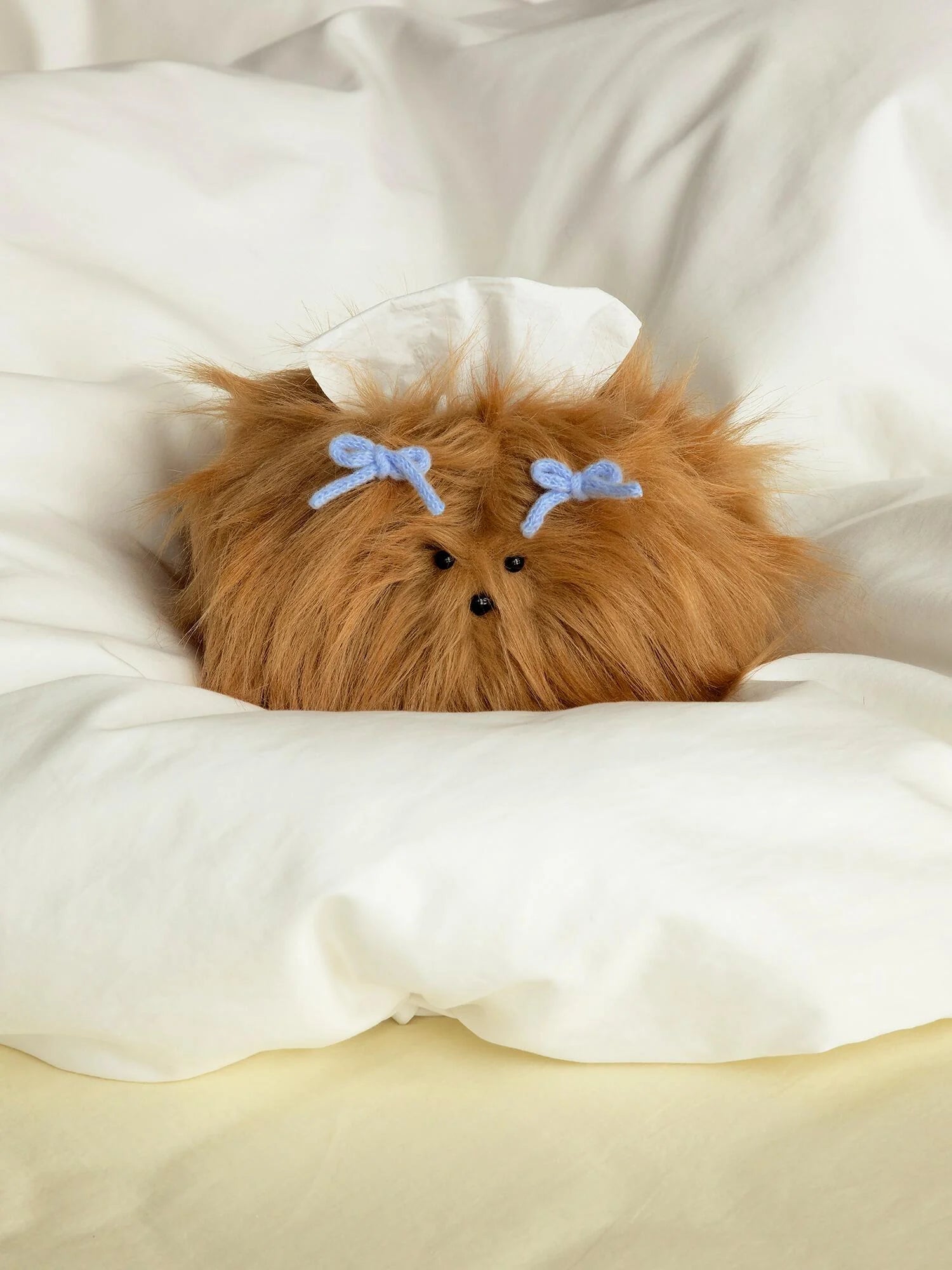 A playful fluffy tissue holder in a sunlit corner