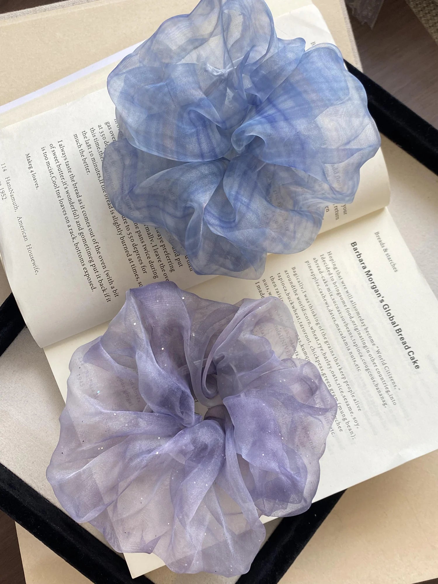Small colourful keepsake boxes held above an open book